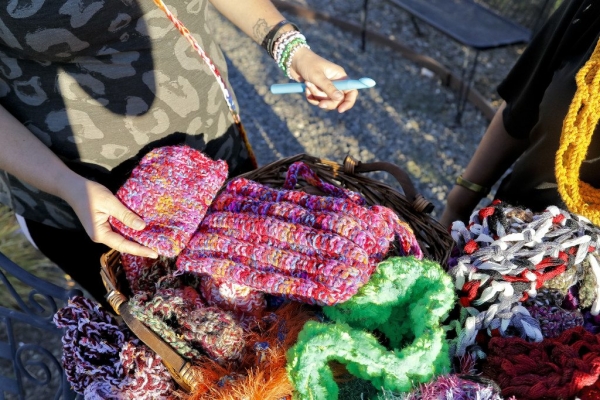 Stephanie Holloway shows off different crochet styles of purses she produced at the Mission Solano Bridge to Life Center, Thursday, Aug. 13, 2015, in Fairfield. The items including scarves, purses, and hats will be sold this weekend at the annual Tomato Festival. (Steve Reczkowski/Daily Republic)