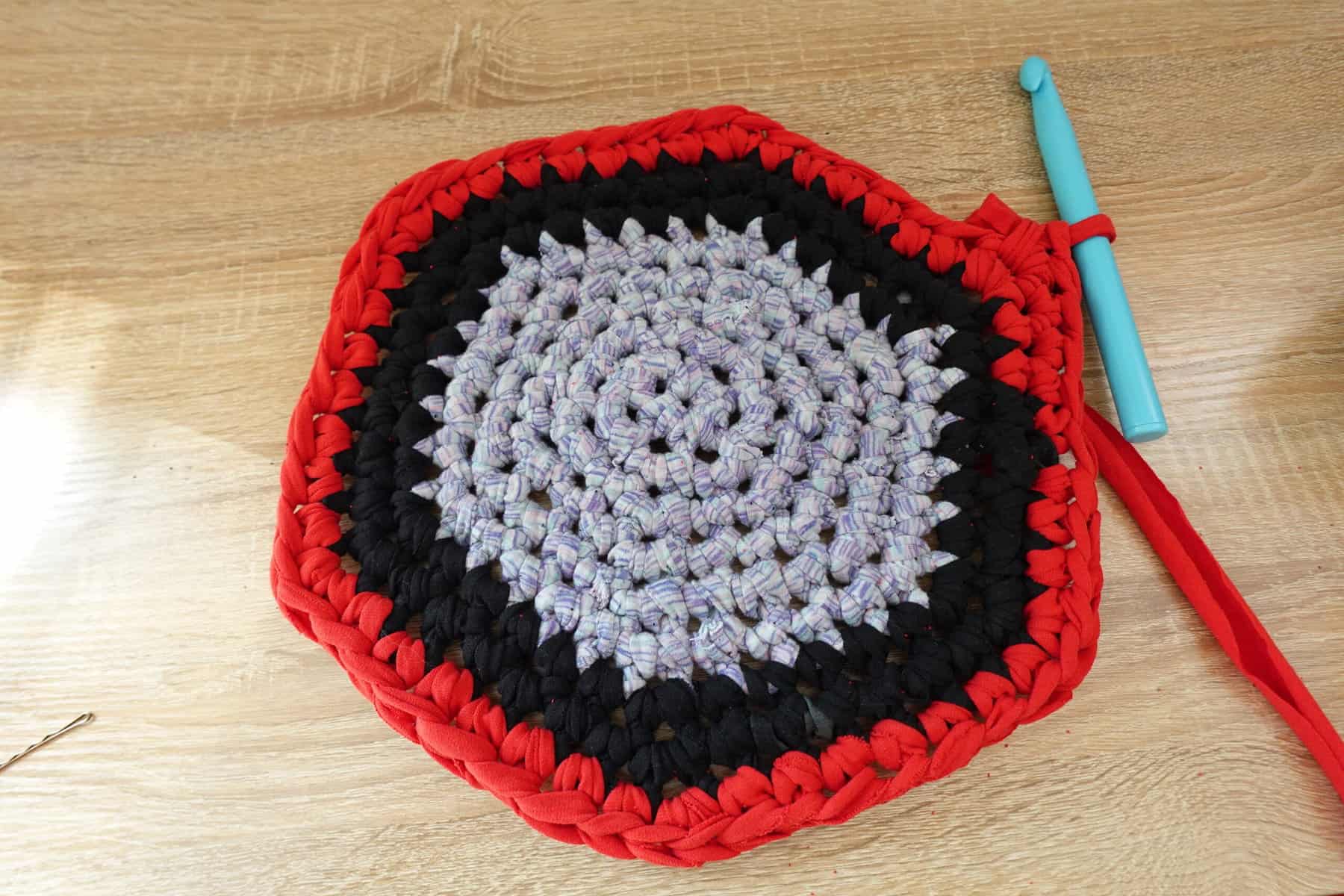 crochet pattern with blue black and red fabric