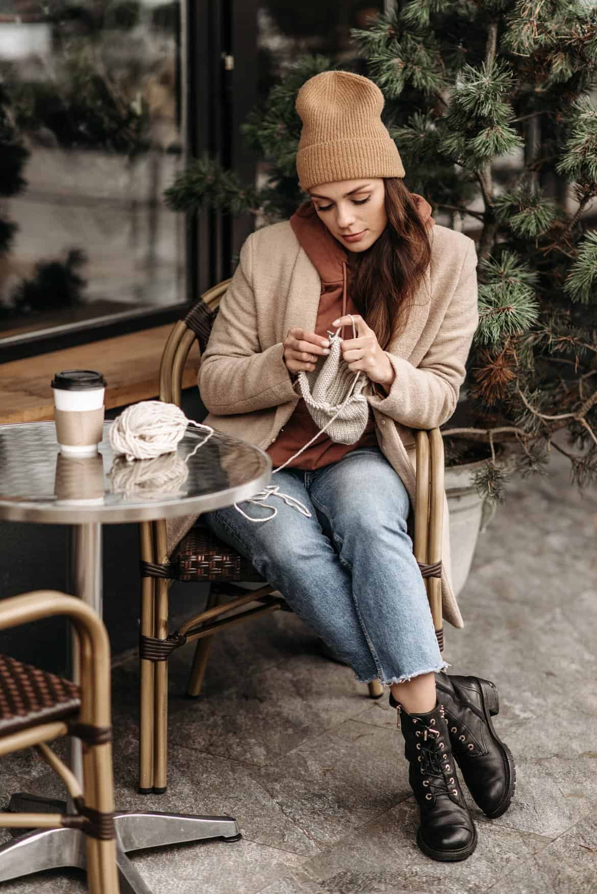 A Woman Enjoying Knitting While Having Coffee Outside