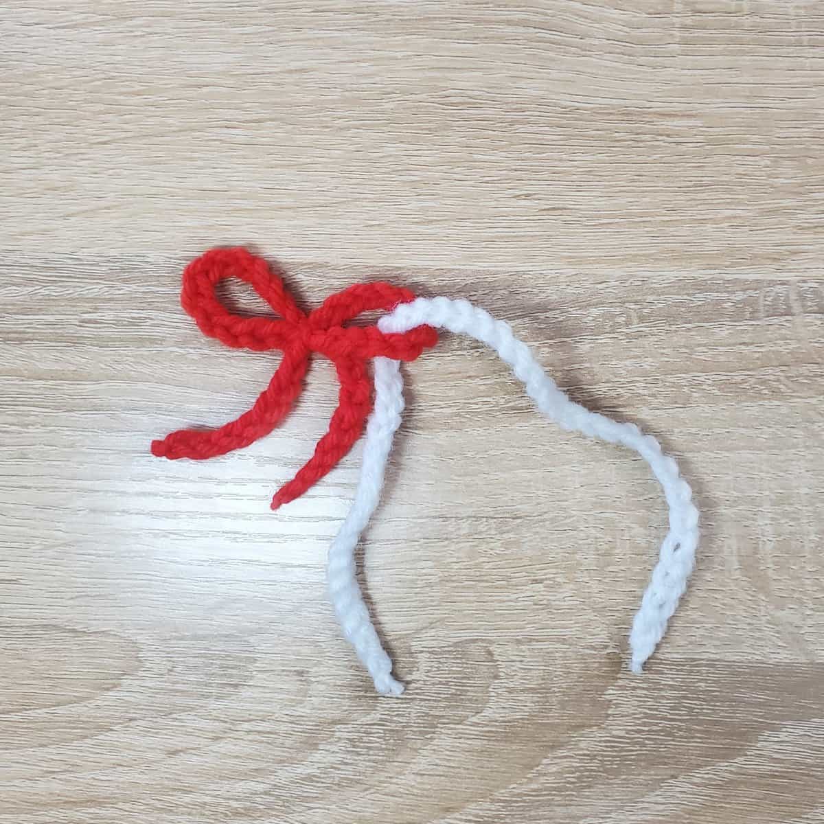 completed crochet bow with white thread