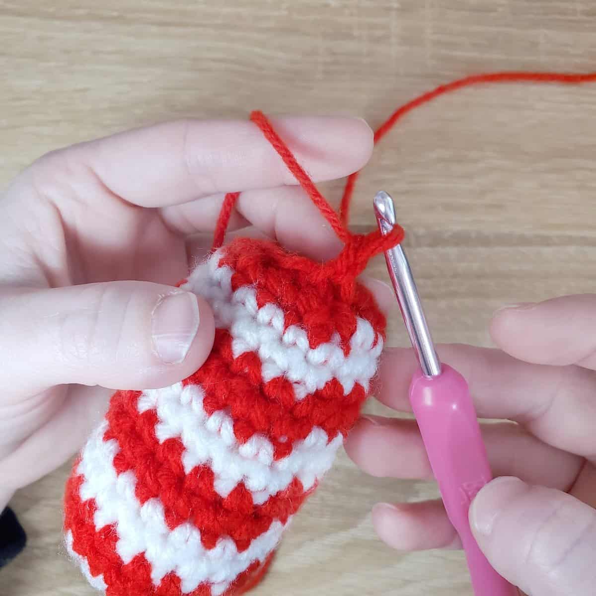 attaching the red yarn to the outermost loop of the BLO stitches