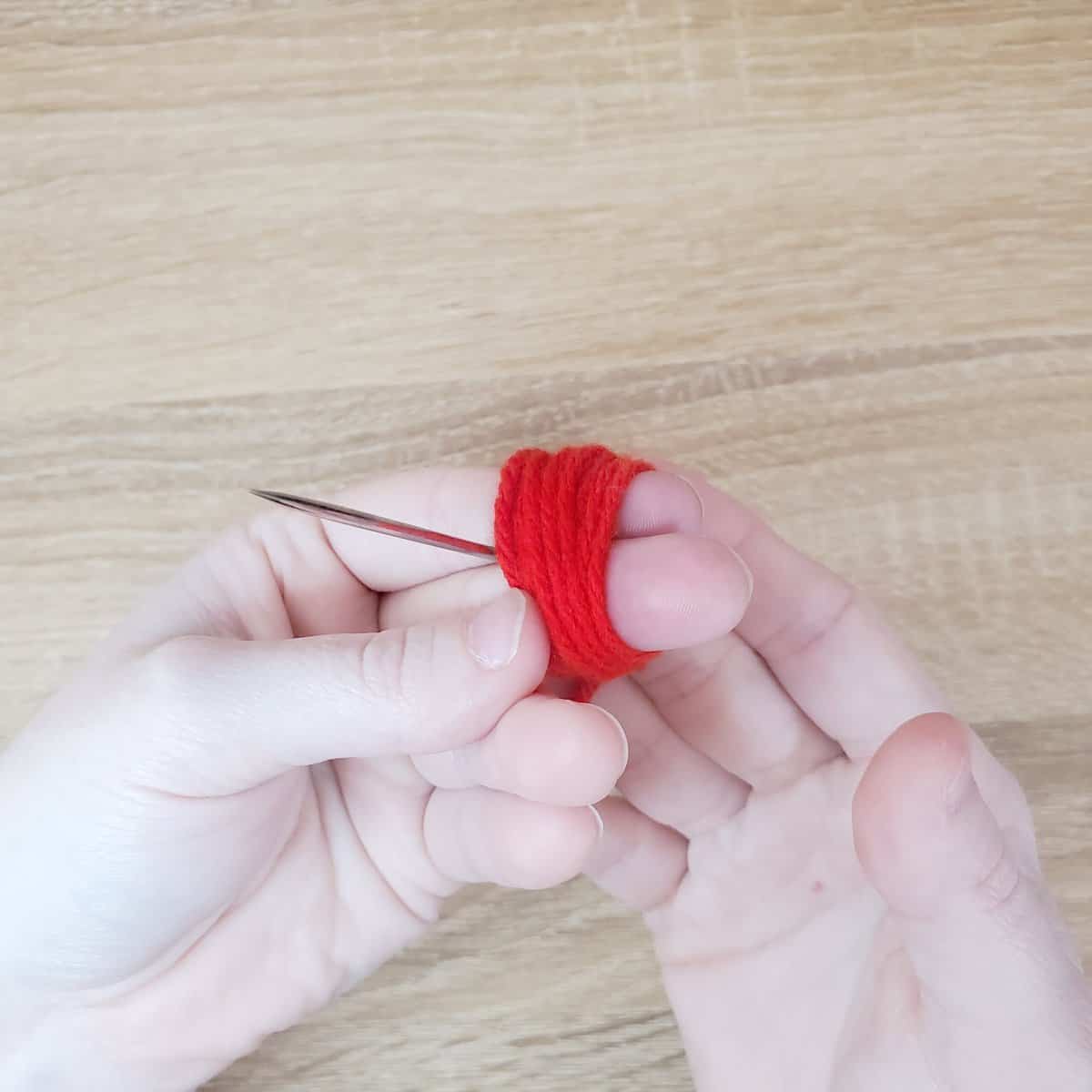 sending the yarn between the index and middle finger