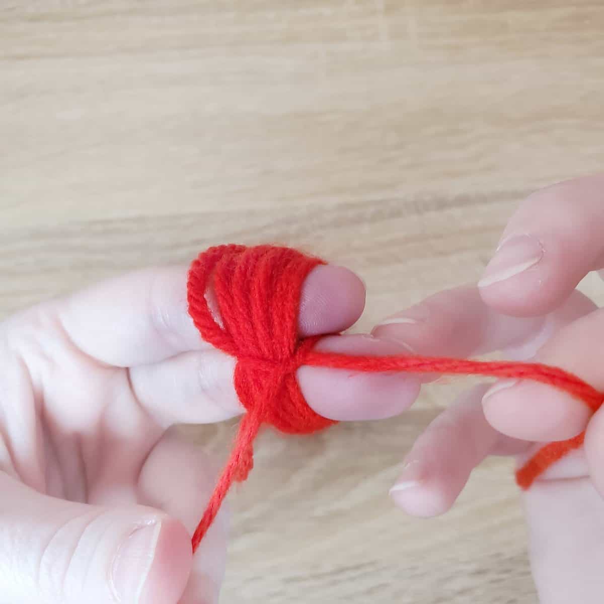tying the two ends of the yarn