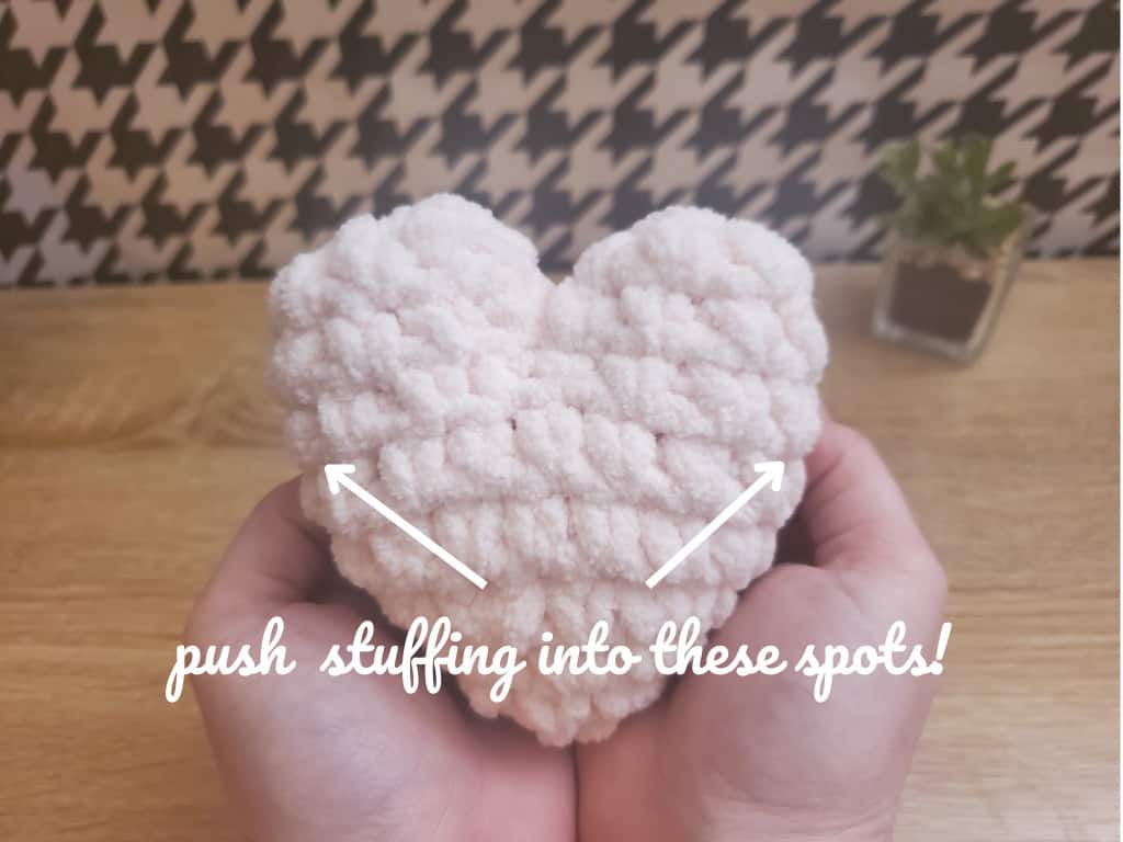 crochet hearts in hands "push stuffing into these spots"