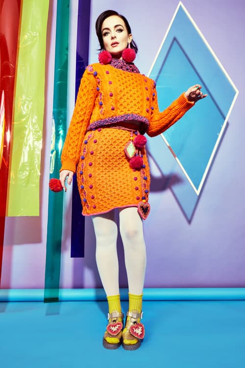 model of European appearance in an orange sweater and a crocheted skirt from designer Katie Jones