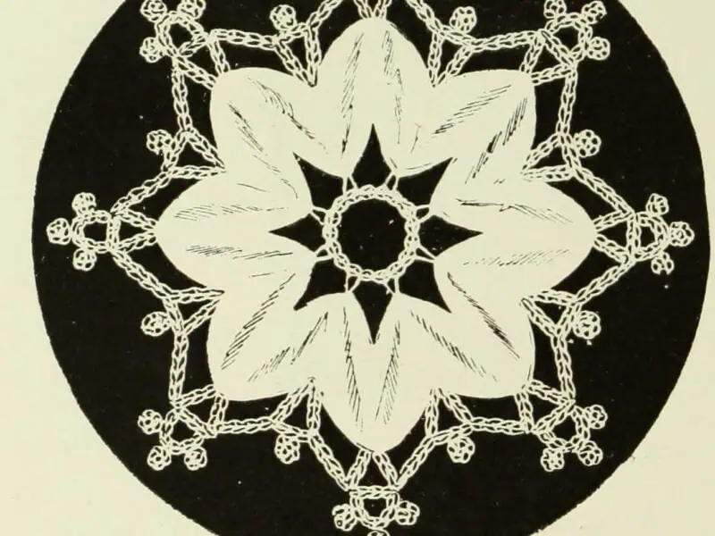 Engraving of a Chinese tape rosette with a crochet picot border, reversed out on a black ground, from The Dictionary of Needlework
